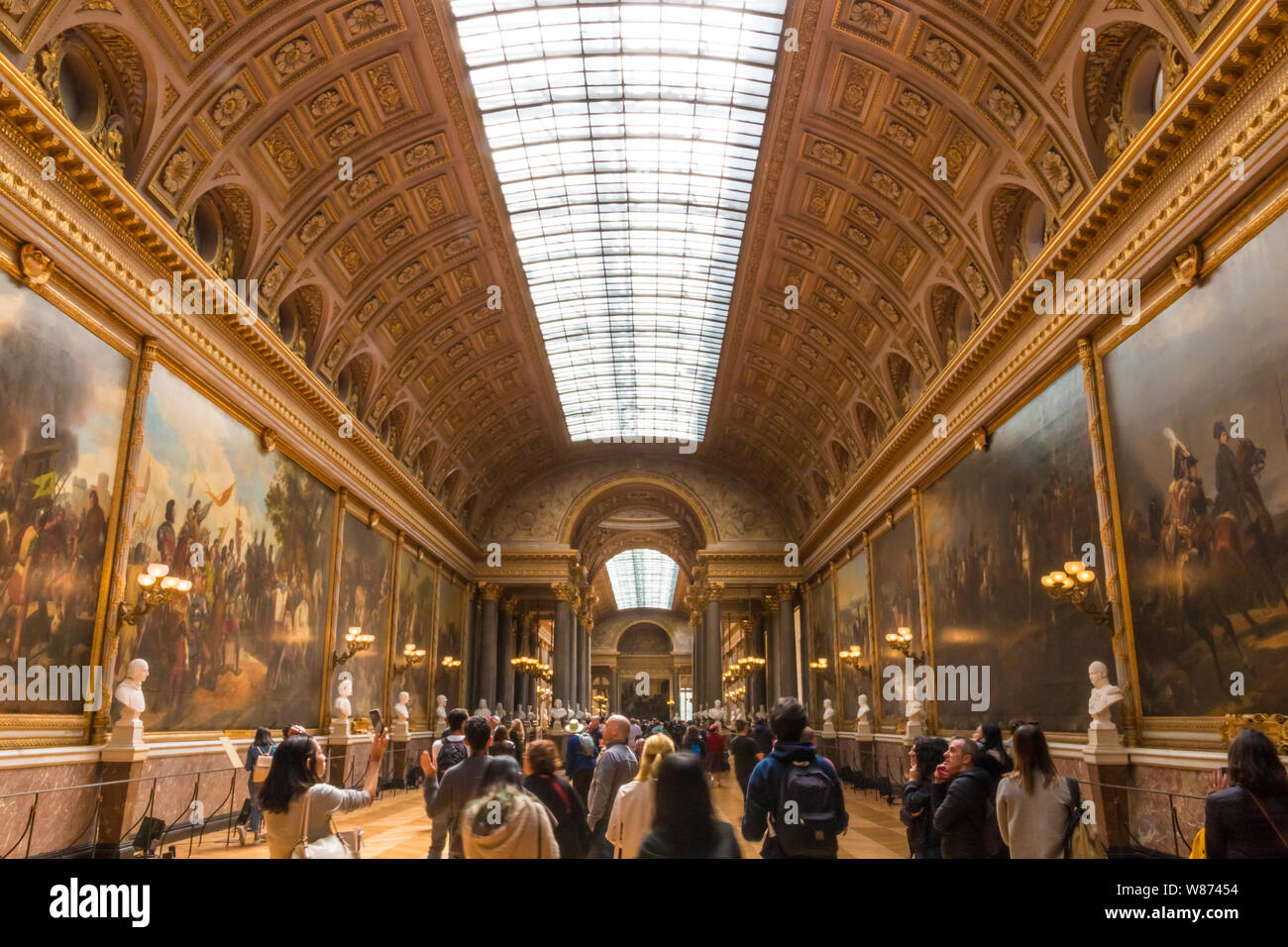 Folla di visitatori a piedi attraverso la galleria di grandi battaglie con vasti dipinti storici di glorificare il più grandi battaglie nella storia militare francese in... Foto Stock
