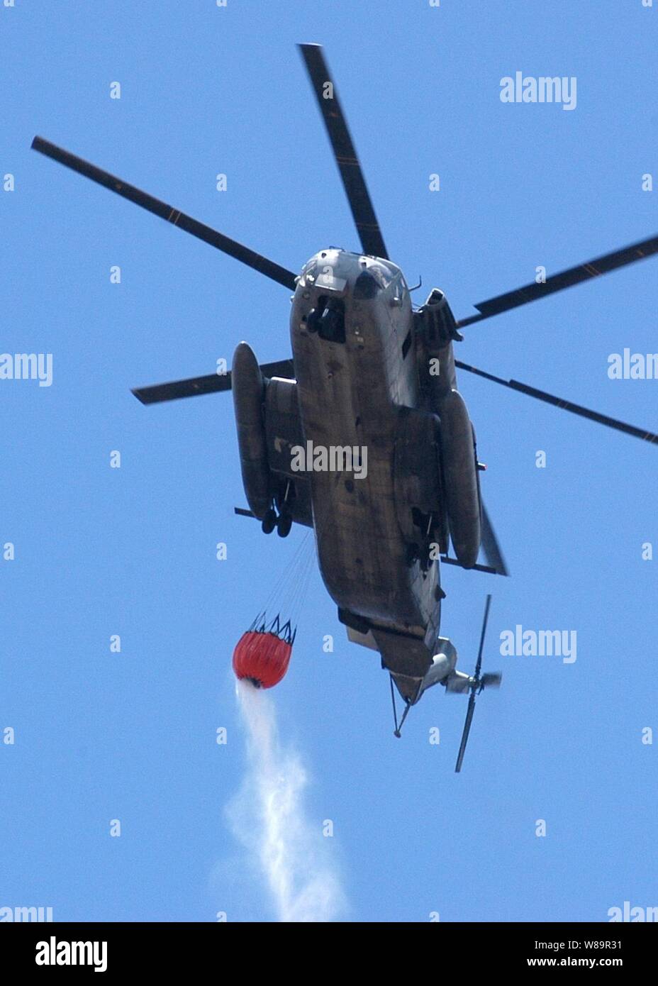 Un U.S. Marine Corps CH-53E Super Stallion elicottero si prepara a scendere più di 2,000 galloni di acqua su un brushfire masterizzazione su Oahu, Hawaii, su agosto 16, 2005. Otto elicotteri militari e nove Vigili del Fuoco motori Fire è venuto in aiuto di Honolulu Vigili del Fuoco in estinzione di Blaze, che consuma più di 3.000 acri. Foto Stock