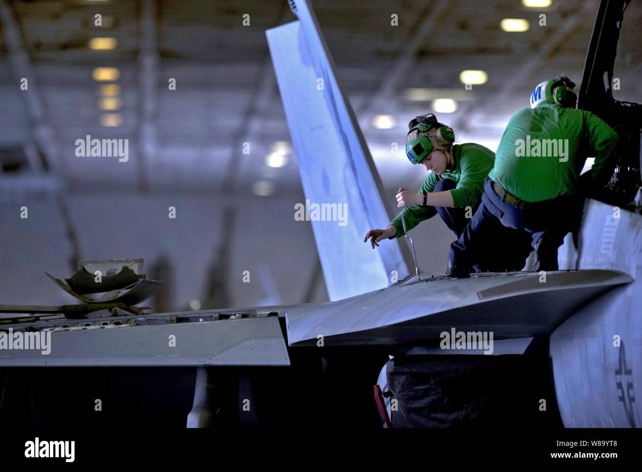 Stati Uniti Navy Petty Officer di terza classe Jessica Murphy, assegnato a Strike Fighter Squadron 22, esegue le operazioni di manutenzione su di un F/A-18F Super Hornet aeromobile a bordo della portaerei USS Carl Vinson (CVN 70) in corso nel Mar Arabico nel febbraio 24, 2011. Foto Stock