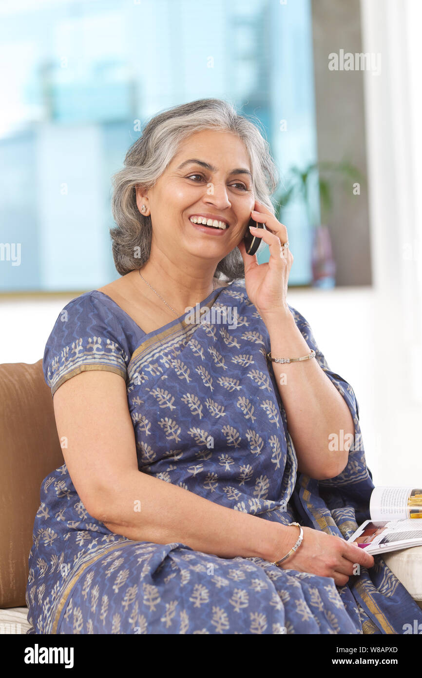 Senior donna a parlare su un telefono mobile Foto Stock
