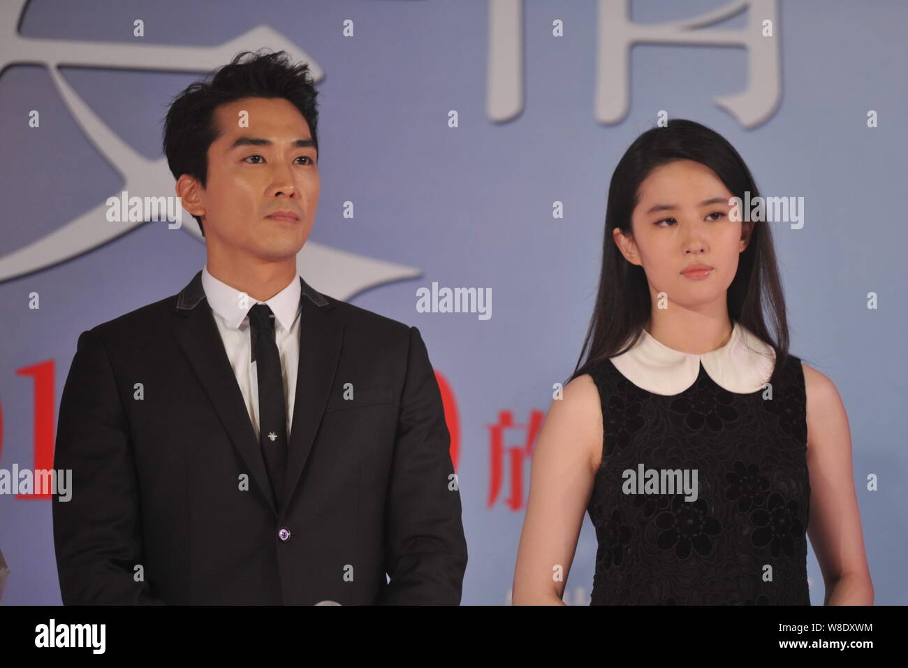 Attrice cinese Liu Yifei, destro e il suo sud coreano attore fidanzato Song Seung-heon osservare un momento di silenzio per piangere le vittime del mortale Foto Stock