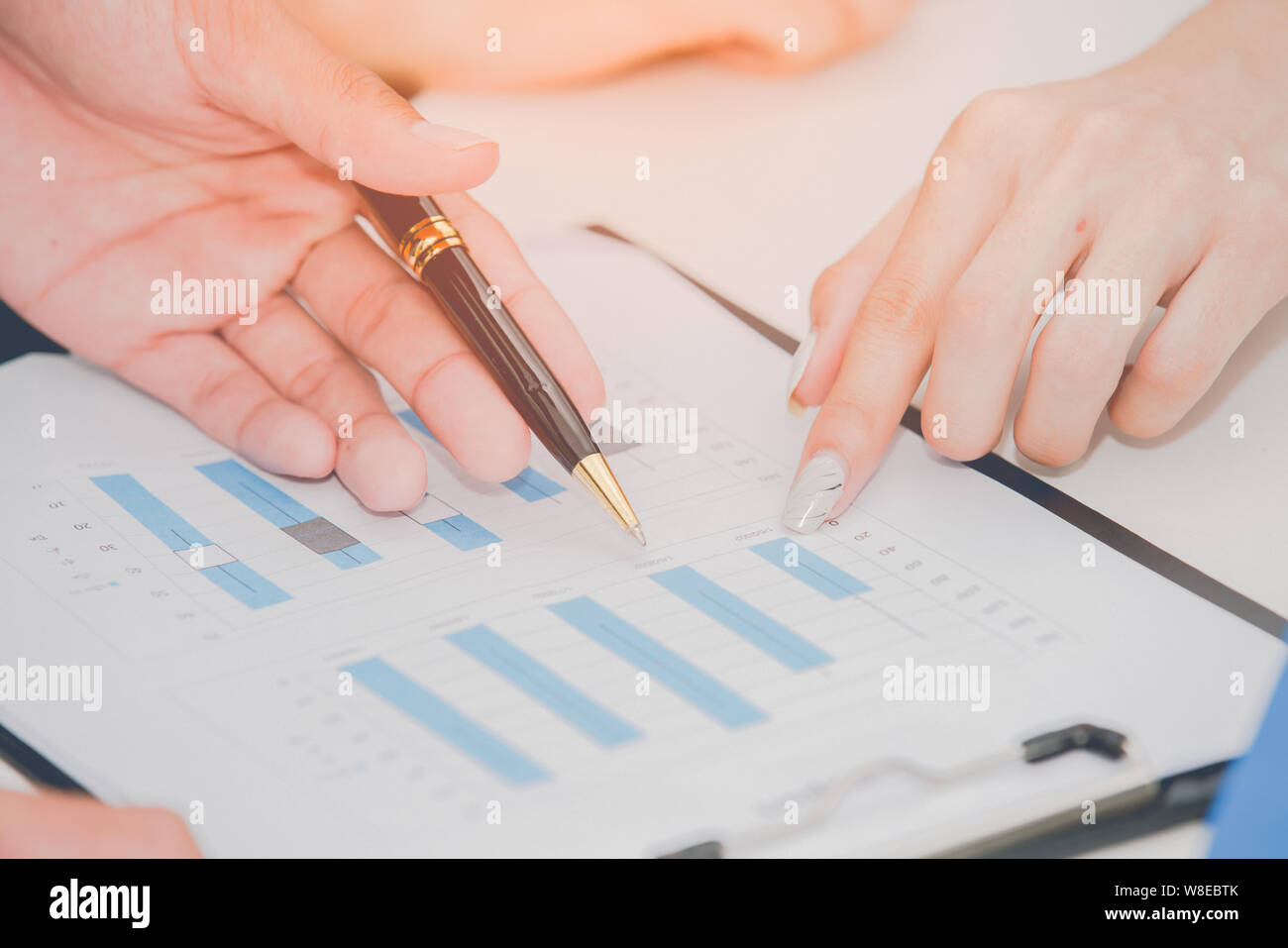 Due business discutendo il regime e maniglie di puntamento sul grafico Foto Stock