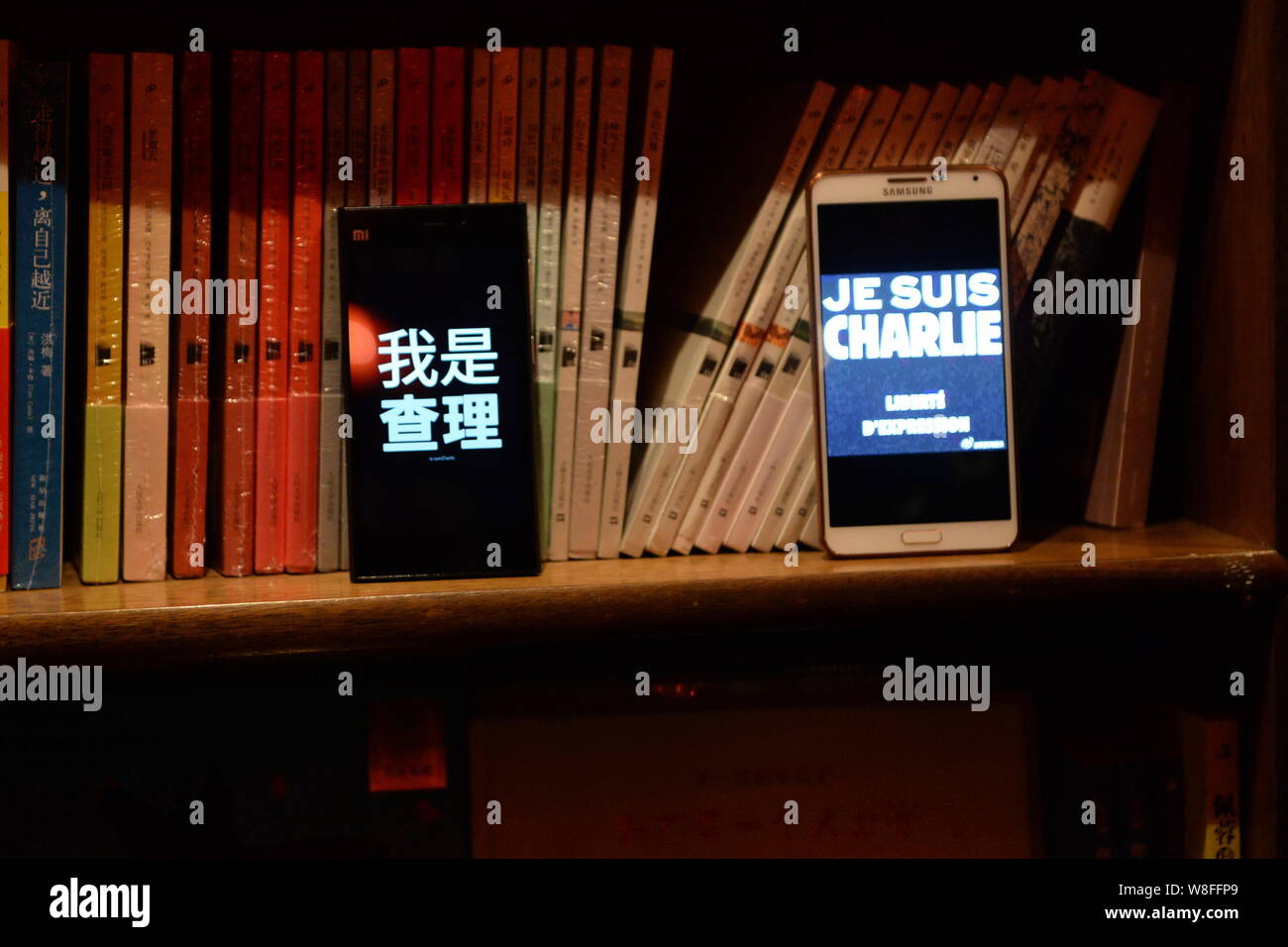 Visualizzazione degli smartphone le parole "IO SONO Charlie" in francese e cinese al cordoglio per le vittime degli attacchi terroristici sul francese settimanale satirico Charlie Foto Stock