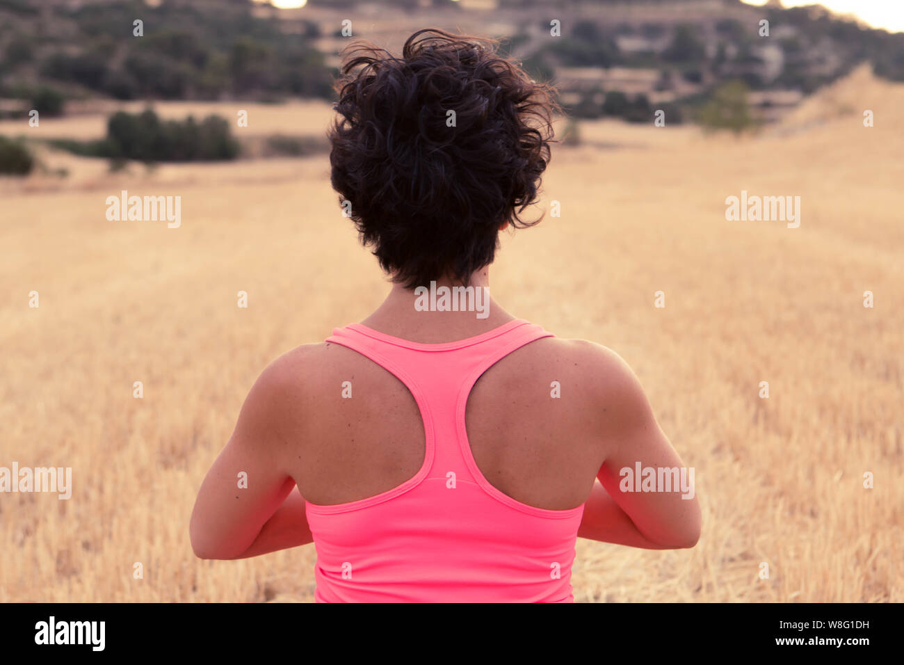 Ragazza giovane la meditazione e la pratica dello yoga al tramonto in un campo aperto. Concetto sano Foto Stock