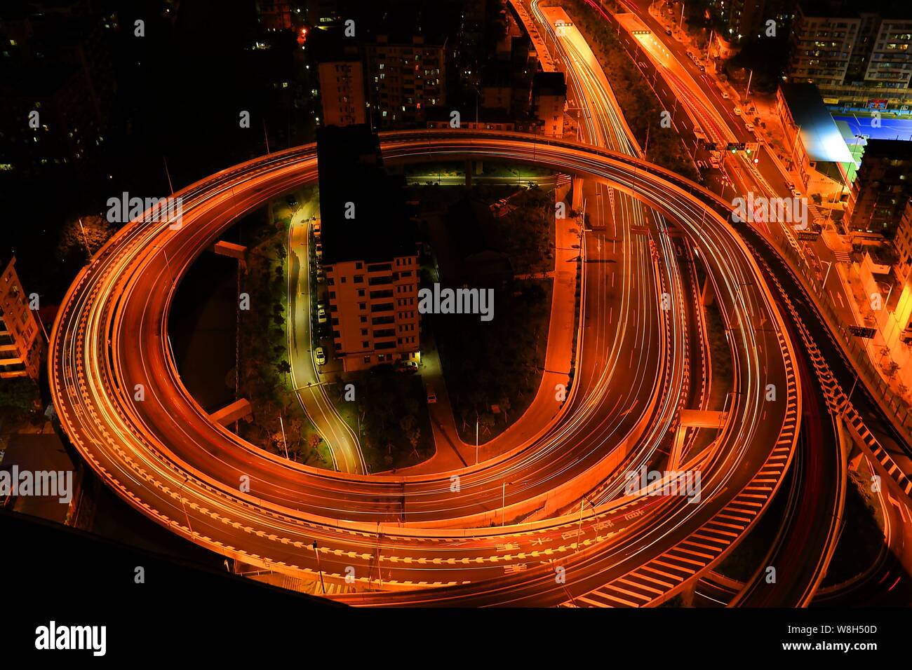 Notte Vista aerea dei due 'nail case " circondata da un cavalcavia che collega il tunnel Zhoutouzui nella città di Guangzhou, a sud della Cina di Guangdong provin Foto Stock