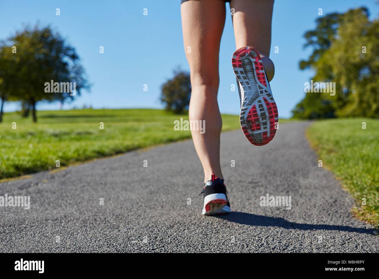 Donna jogging su un percorso. Foto Stock