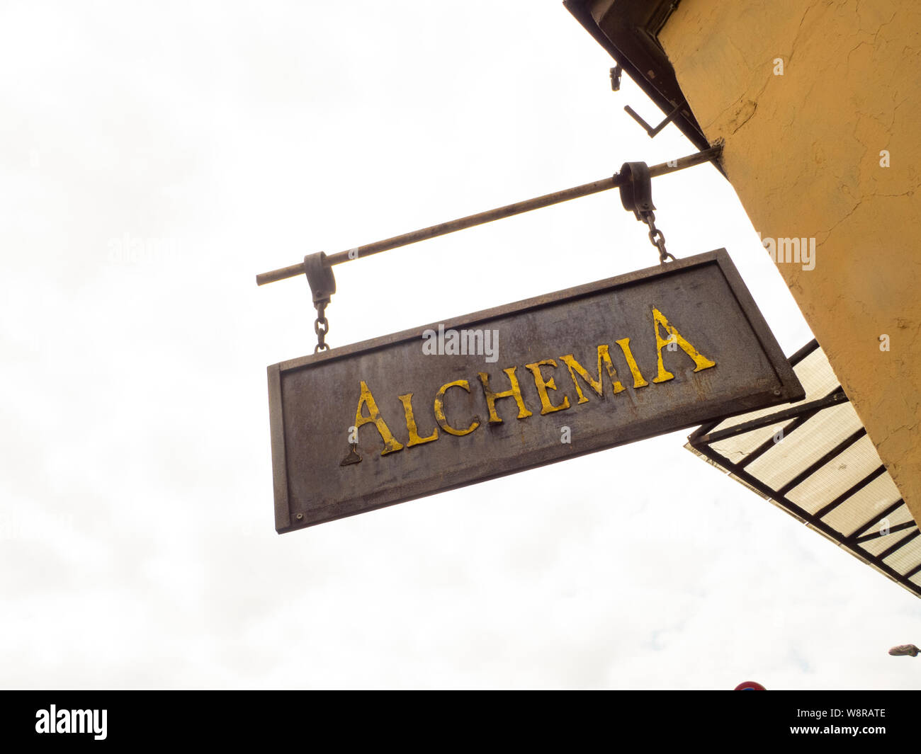 Kracow, Poland-Juni 10,2015: weathered segno metallico dicendo Alchemy è sospeso verso il basso su un muro di casa Foto Stock