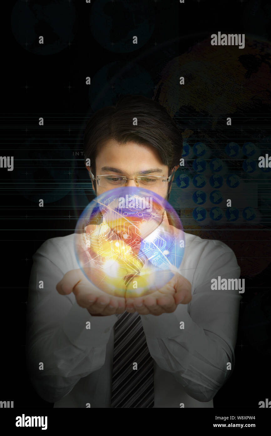 Uomo d'affari con un mondo di circuiti Foto Stock