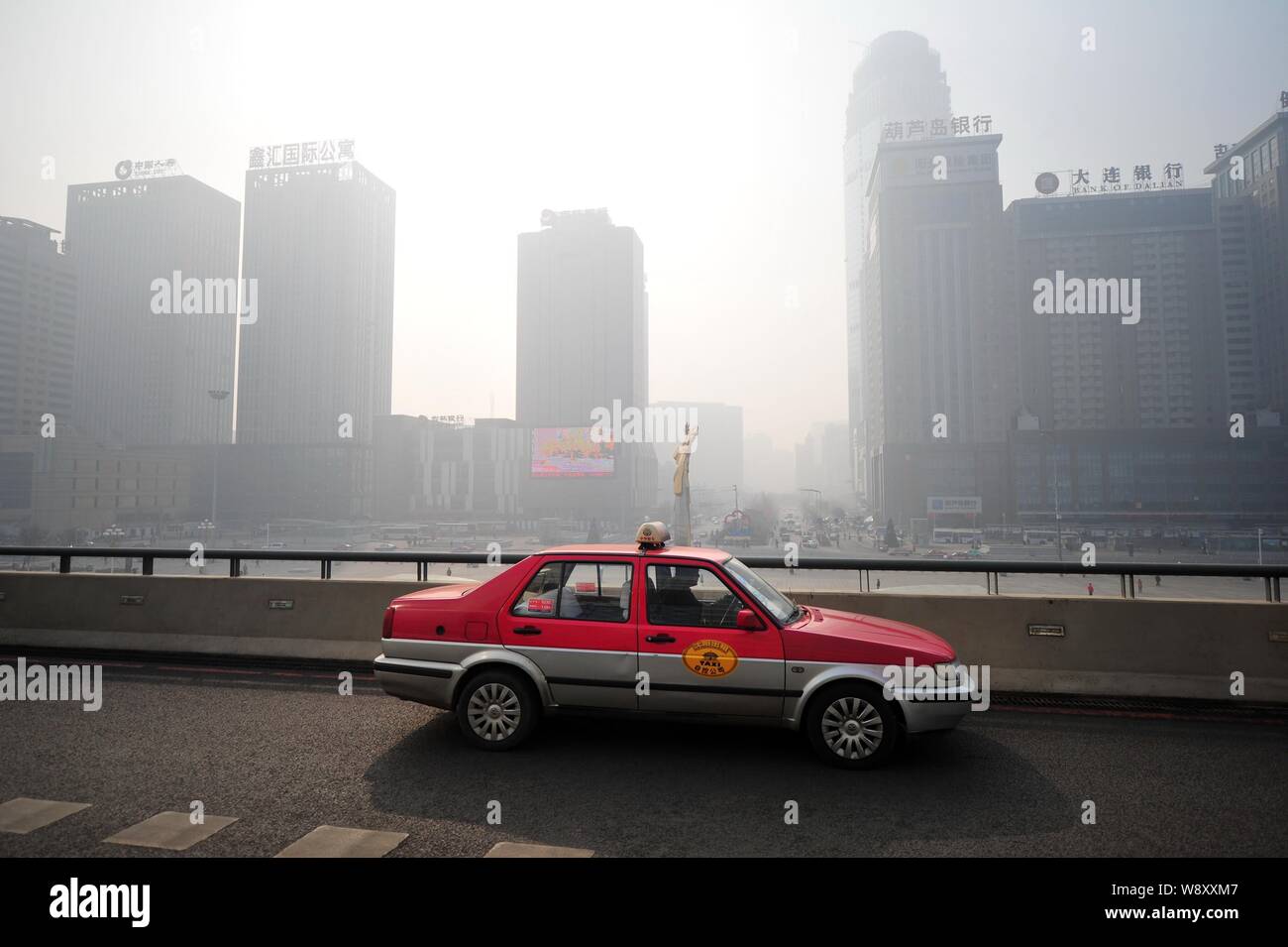 Un taxi viaggia su una strada sopraelevata di smog pesante in Shenyang city, nordest Chinas provincia di Liaoning, 27 marzo 2014. Lo smog spessa ha continuato a aff Foto Stock