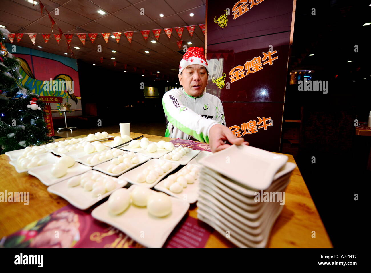 Il cinese big eater Pan Yizhong mangia uova durante una cena di Natale sfida a mangiare in un ristorante a buffet nella città di Changsha, centrale cinese di Hunan prov Foto Stock