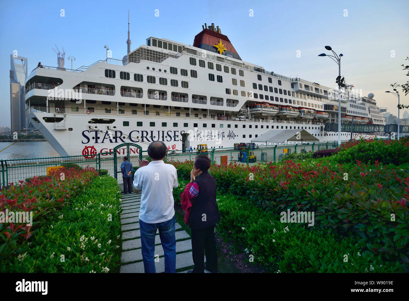 --FILE--persone guardano la nave da crociera Gemini di Star Cruises presso il porto di Shanghai International Cruise Terminal in Cina a Shanghai, 24 maggio 2013. C Foto Stock