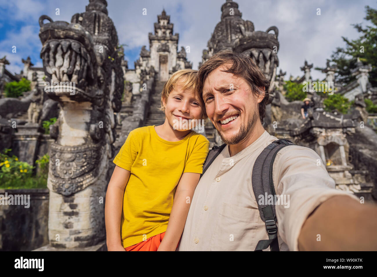 Papà e figlio turisti su sfondo di tre scale di pietra in bella Pura Luhur Lempuyang tempio. Portali Paduraksa marcatura entrata al centro Foto Stock