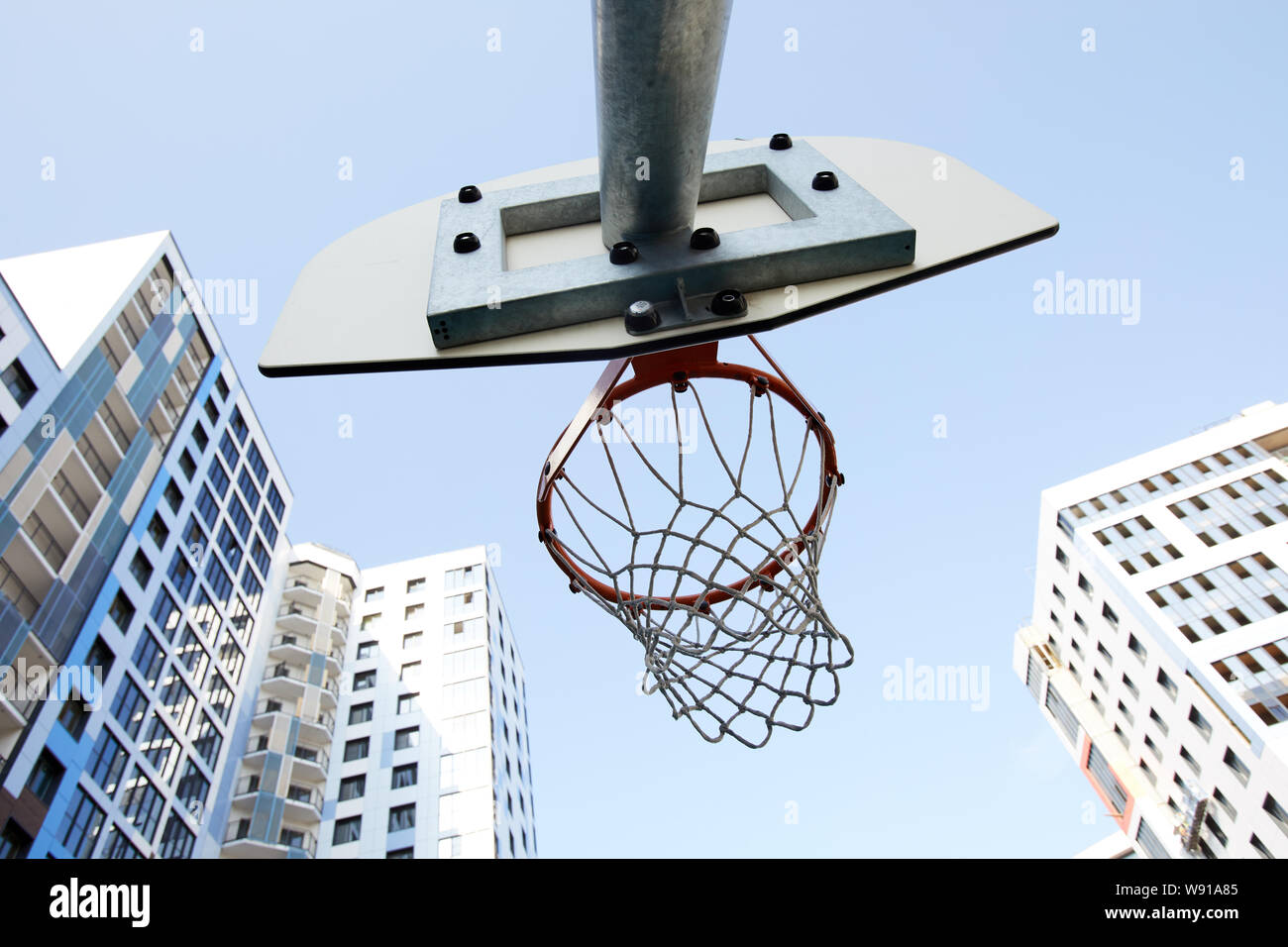 Basso angolo vista di Basketball hoop in background urbano, spazio di copia Foto Stock