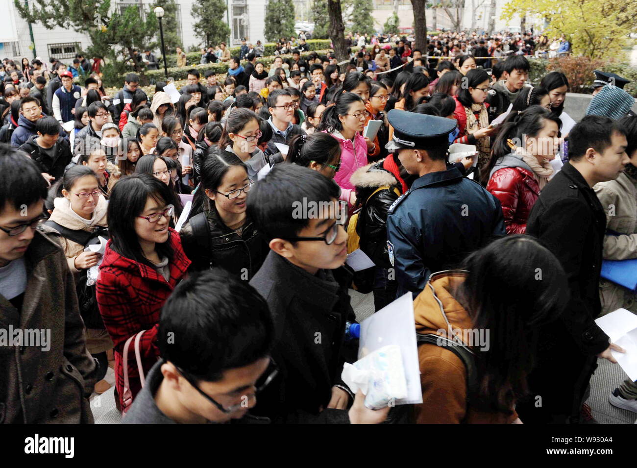 Una folla di cinesi examinees greggi in un esame sito per prendere parte al servizio civile nazionale esame alla Beijing Jiaotong University di Pechino Foto Stock