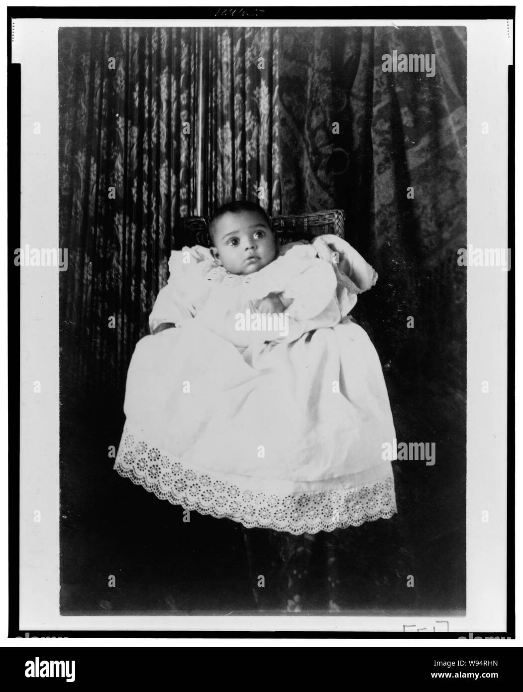 African American baby, ritratto a figura intera, indossare un abito battesimo Foto Stock