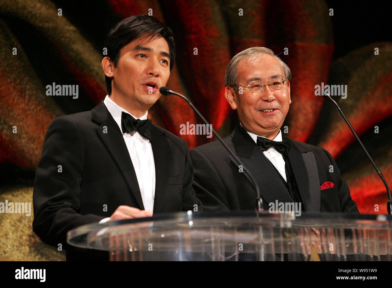 --FILE--Hong Kong cantante e attore Tony Leung Chiu Wai, sinistra, parla accanto a Rafael Hui Si Yan, Segretario generale dell'amministrazione di Hong Kong, a th Foto Stock