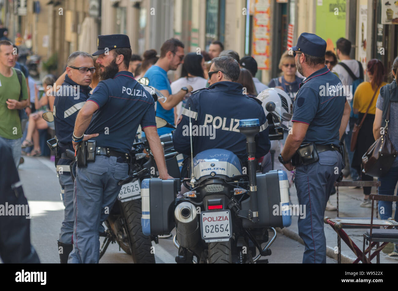 Un gruppo di poliziotti di stare nella strada principale di Palermo vicino la polizia moto Foto Stock