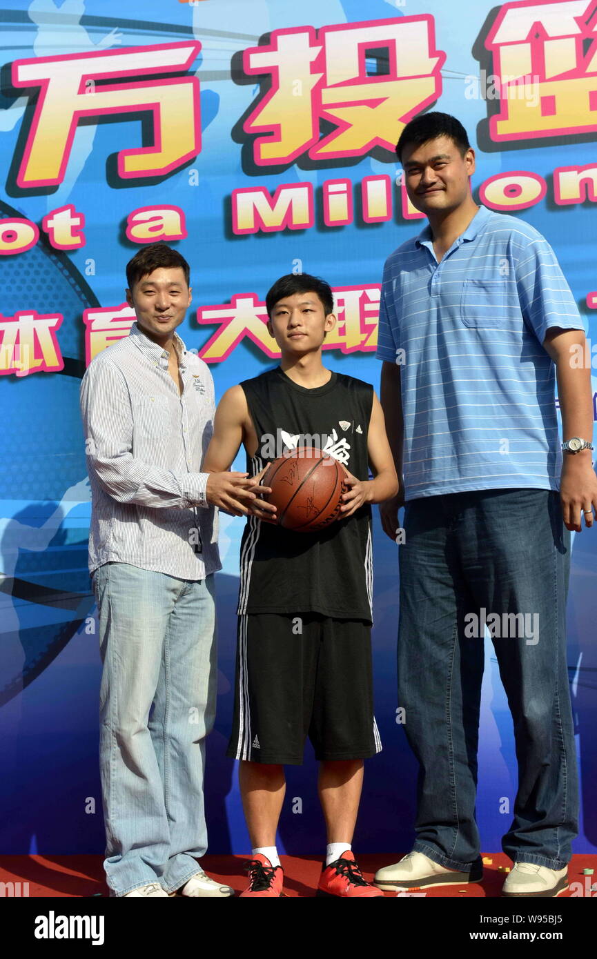 Pensionato cinese superstar di basket Yao Ming, destro e il suo ex compagno di squadra Liu Wei, sinistra, posano con un giovane giocatore di basket durante il lancio cer Foto Stock