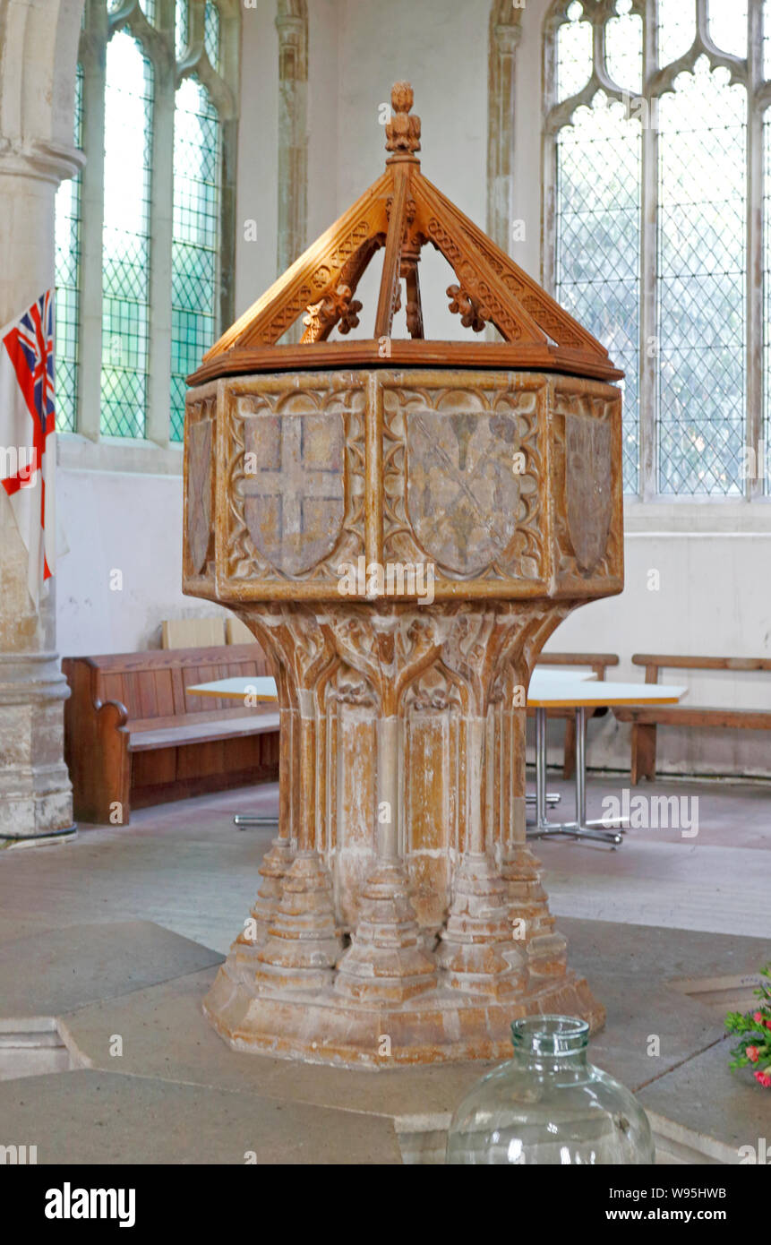 Una vista di pianta ottagonale del xv secolo font nella chiesa parrocchiale di tutti i santi a Thornham, Norfolk, Inghilterra, Regno Unito, Europa. Foto Stock