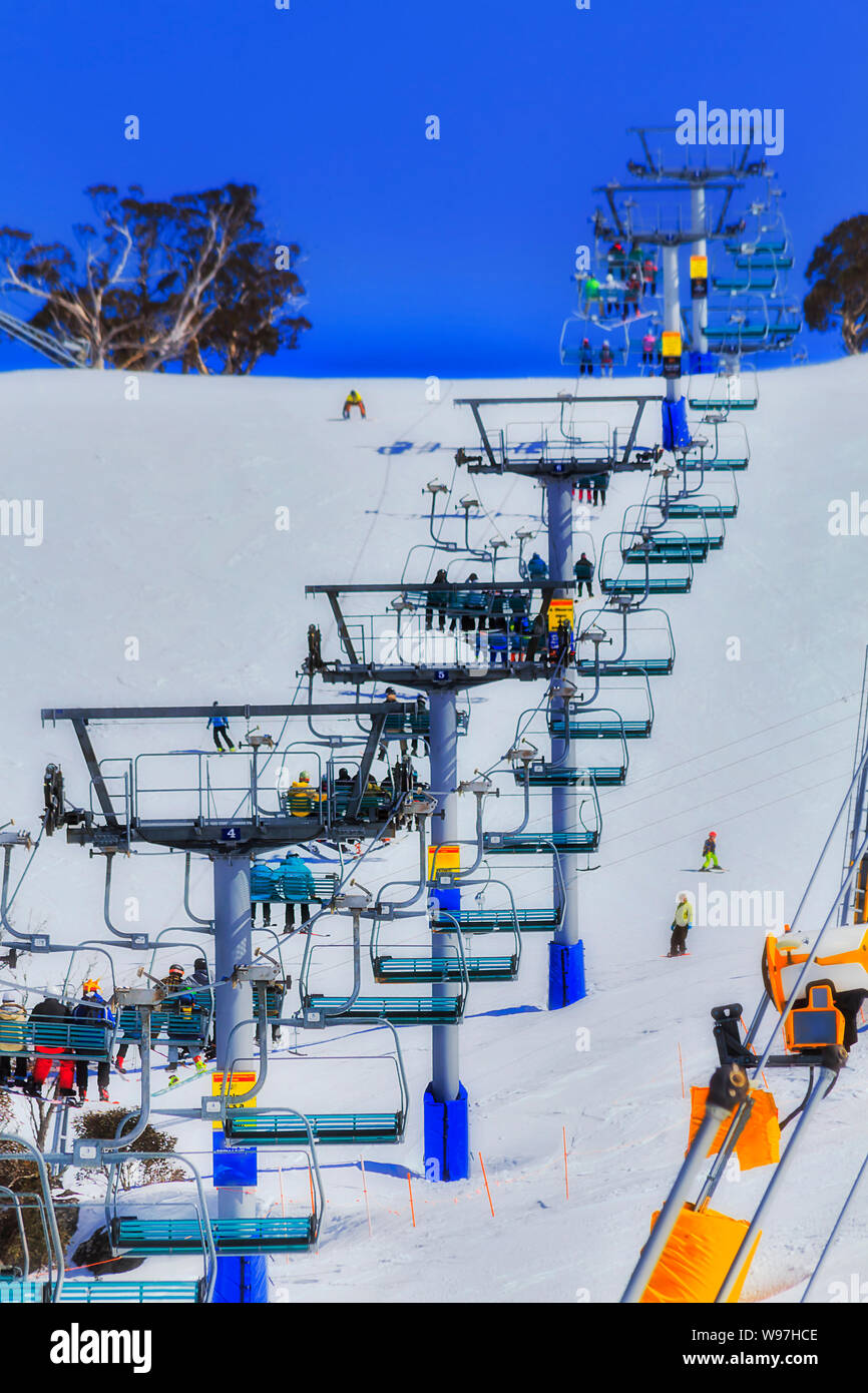 Montagna innevata sci e snowboard winter resort - Perisher valle valle anteriore seggiovie portando le persone attive fino alle cime di t circostante Foto Stock
