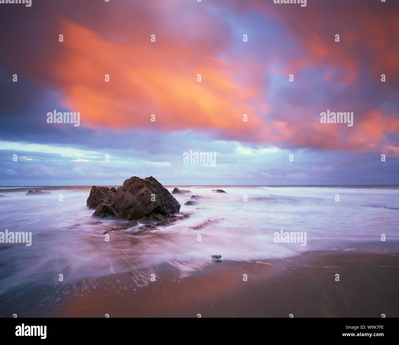 Widemouth Bay all'alba, con rocce offshore e red storm clouds overhead, vicino a Bude, Cornwall, England, Regno Unito, Europa Foto Stock