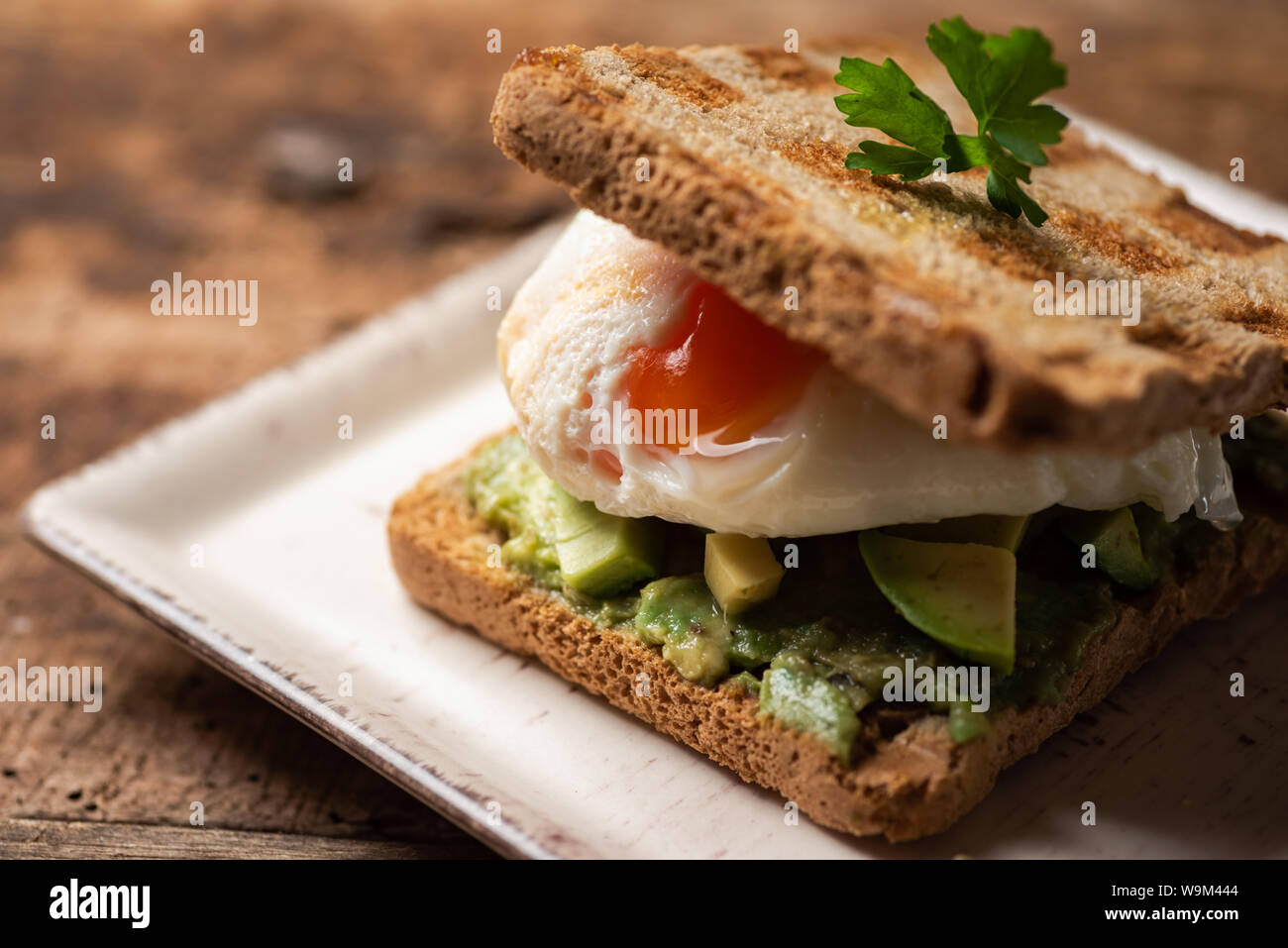 Freschi sandwich toast con uova fritte e avocado Foto Stock