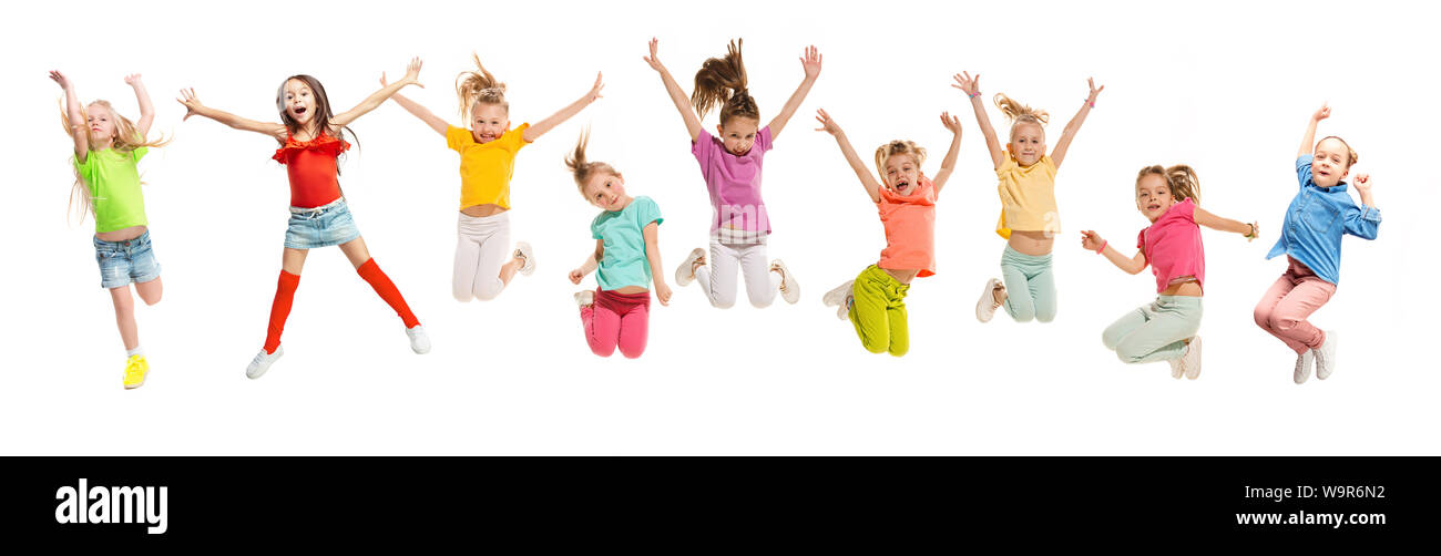 Gruppo di scuola elementare i bambini o gli studenti jumping in colorate abiti casual jumping isolato su bianco di sfondo per studio. Collage creativi. Si torna a scuola, l'istruzione, il concetto di infanzia. Foto Stock