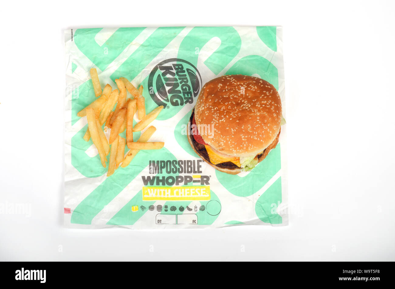 Burger King Whopper impossibile con formaggio e patatine fritte sul wrapper, un vegetariano, senza carne, impianto basato a sandwich Foto Stock