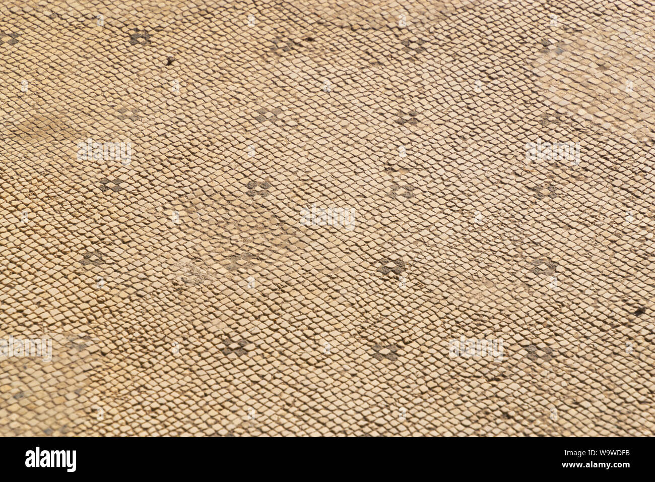 Antiche tessere di mosaico con pattern di piccole dimensioni, in stile romano dello sfondo. Foto Stock