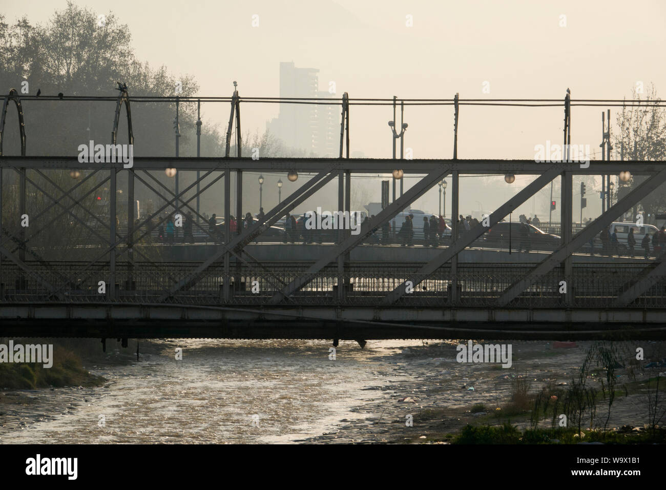 Pedoni e il traffico sul ponte sopra il fiume Mapocho, a Santiago del Cile Foto Stock