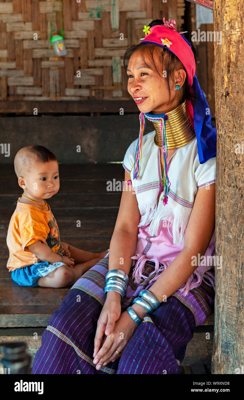 Ritratto di un lungo collo donna o Paduang del Karen tribù etniche, con il suo bambino, nella regione di Mae Hong Son da confine con il Myanmar, Thailandia. Foto Stock