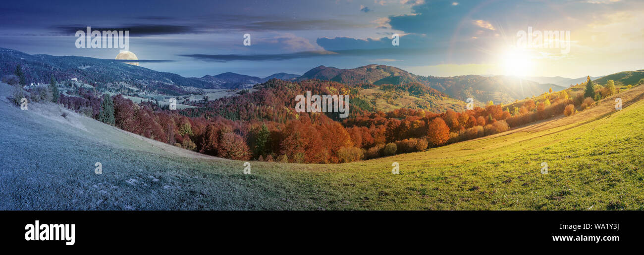 Il giorno e la notte e cambiare idea al di sopra di paesaggio panoramico in ottobre. prato erboso e alberi in caduta delle foglie. La gamma della montagna nella distanza beneat Foto Stock