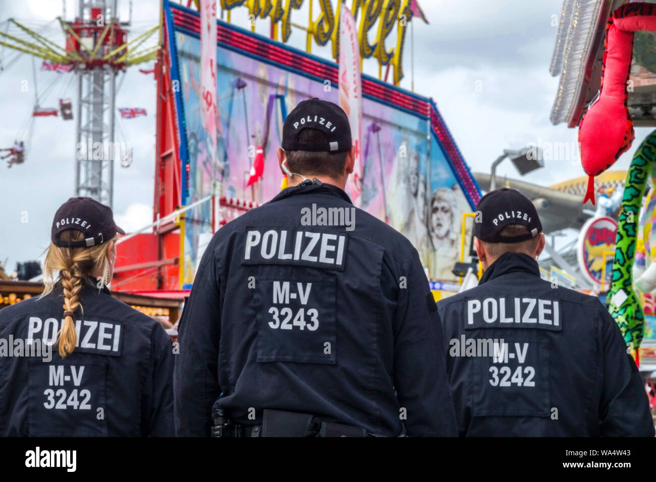 Tre-uomo donna tedesca di pattuglia di polizia nel parco di divertimenti, Germania cooperazione di polizia Foto Stock