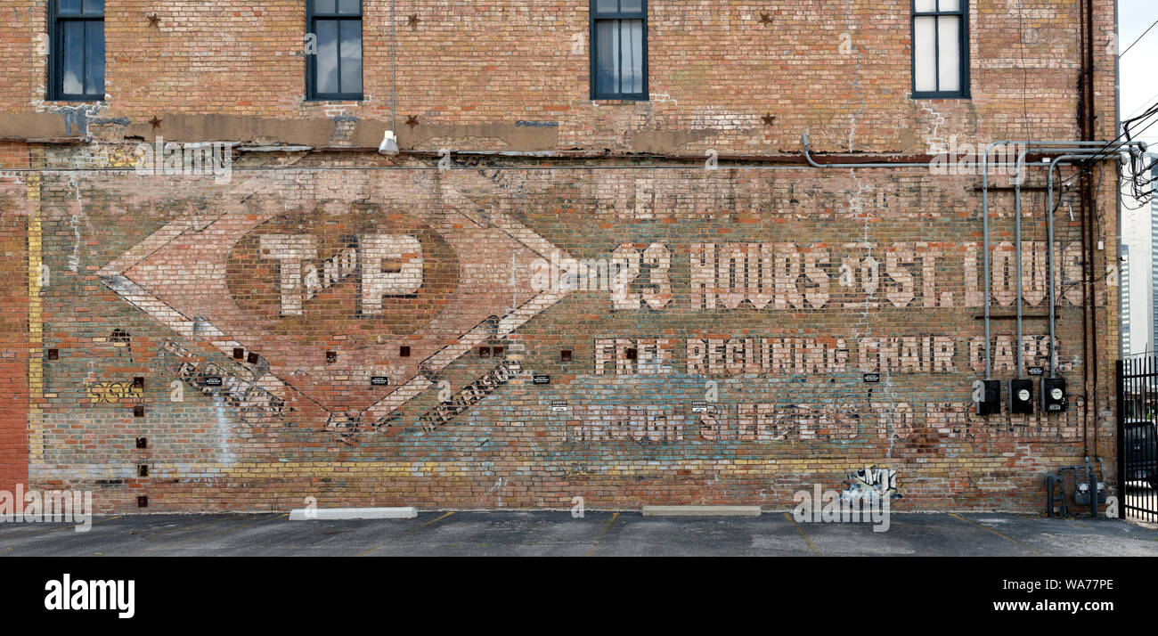 Un murale sbiadito sul muro di un edificio a Dallas, in Texas, pubblicità il Texas e Pacific Railroad del servizio passeggeri a Saint Louis in ciò che al momento è stato apparentemente il rapido tempo di 23 ore Foto Stock