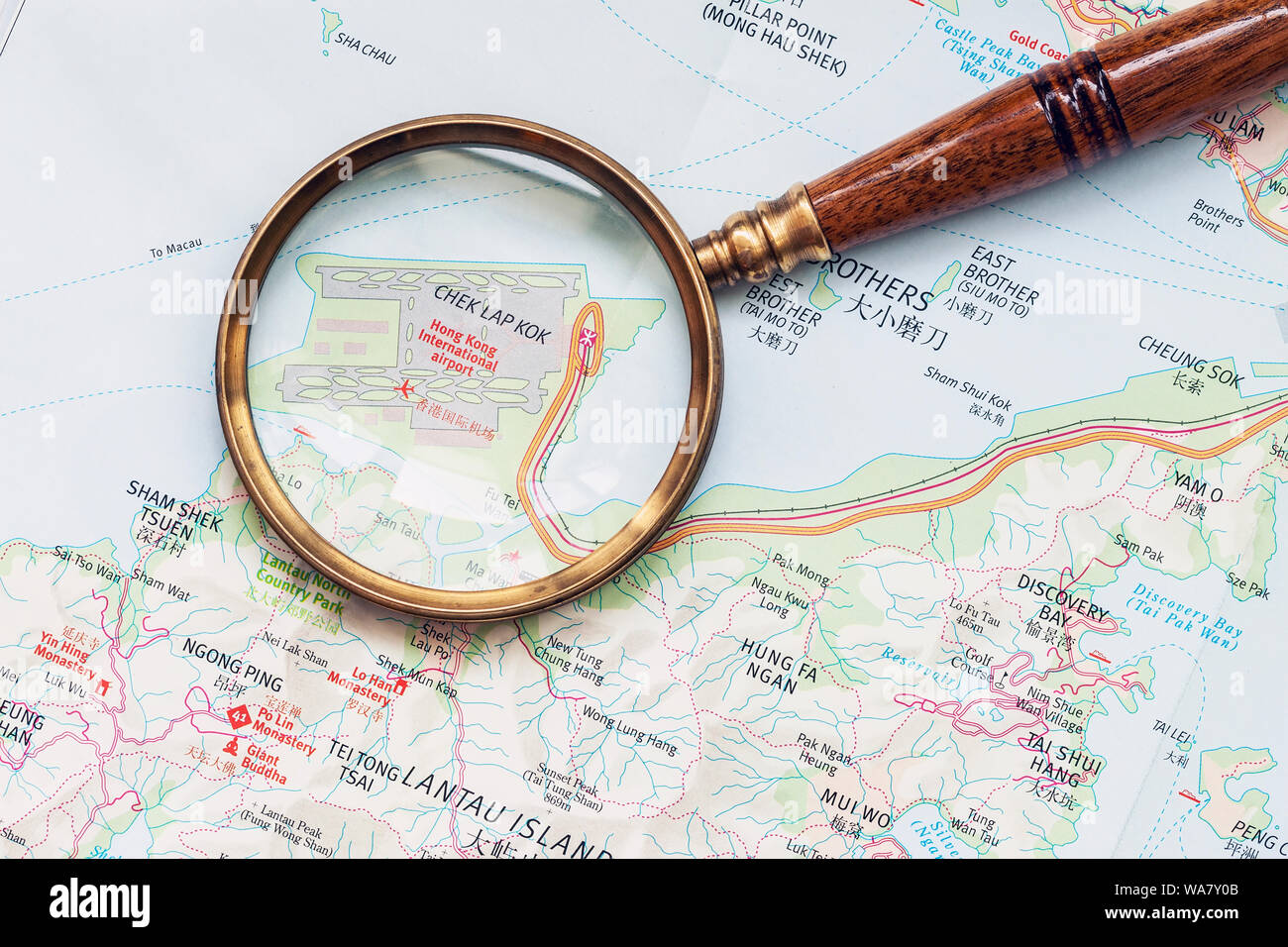 Aeroporto di Hong Kong city su una mappa geografica attraverso la lente di ingrandimento Foto Stock