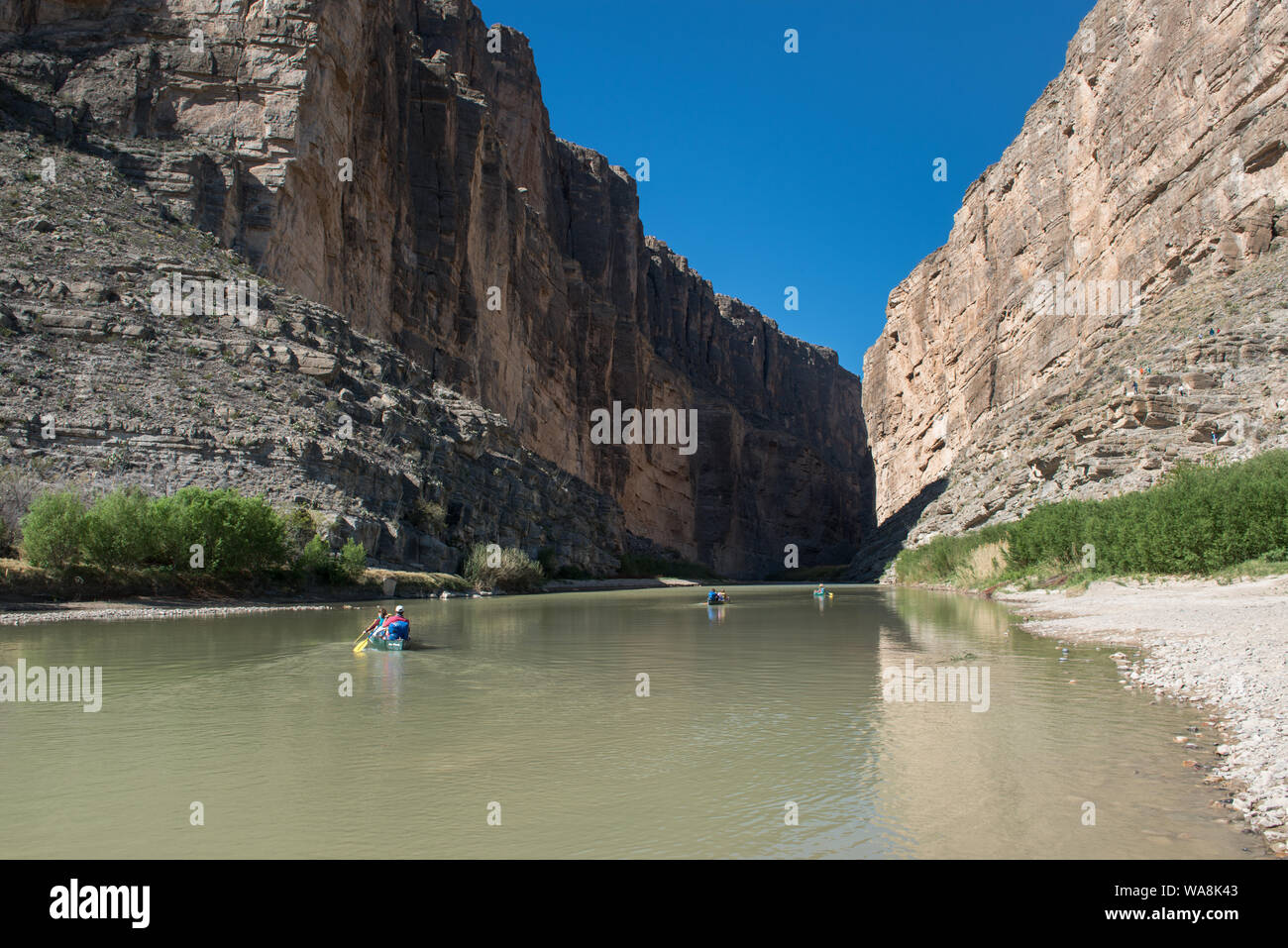 Canoers impostato su off per navigare il Fiume Rio Grande tra le ripide pareti rocciose di Santa Elena Canyon, profonda nel Parco nazionale di Big Bend in Brewster County, Texas. Il Messico è a sinistra, gli Stati Uniti a destra Foto Stock