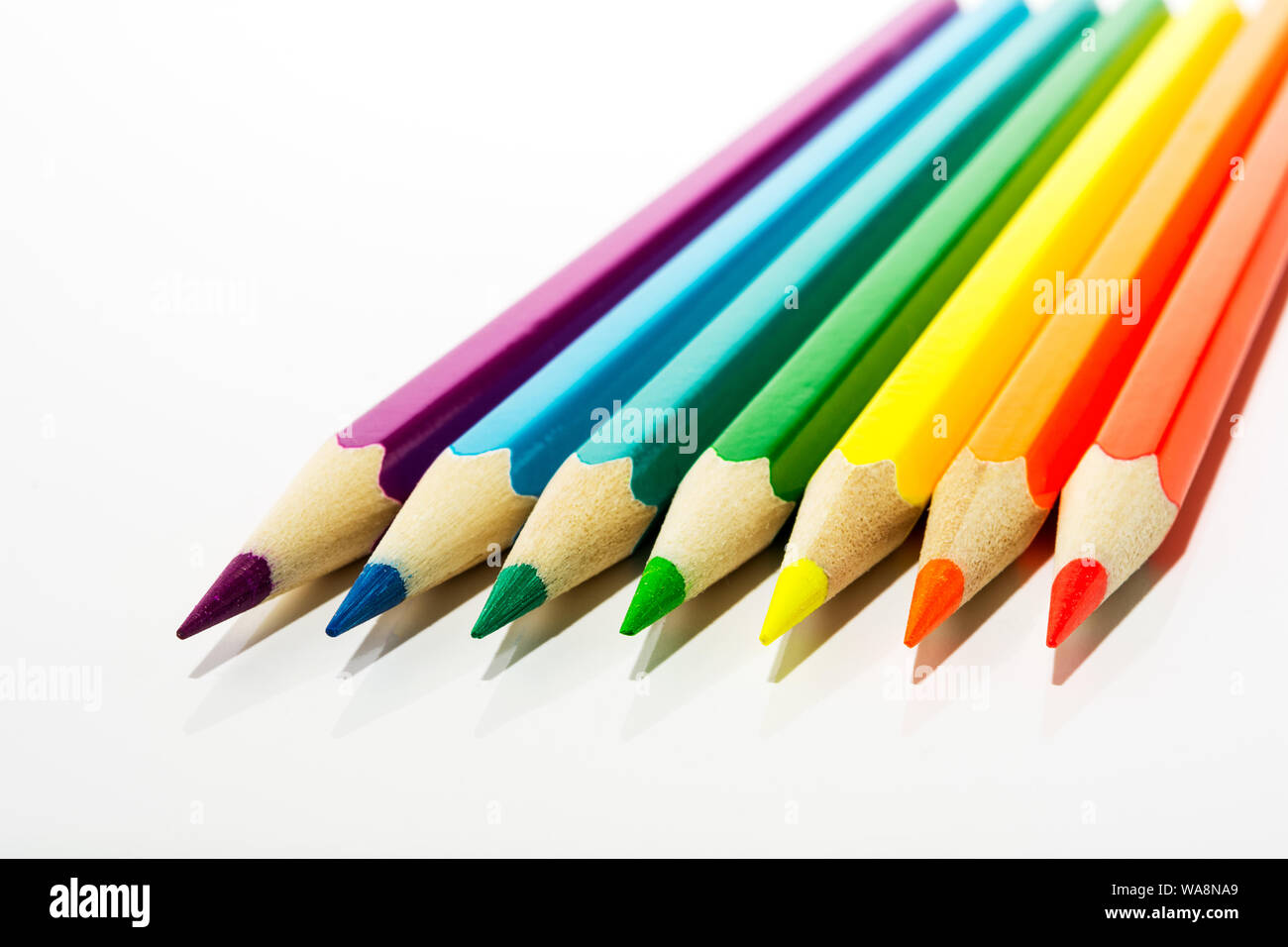 Rosso, arancione, giallo, verde, blu, viola kid's matite colorate come un simbolo dei primi passi dell'artista Foto Stock