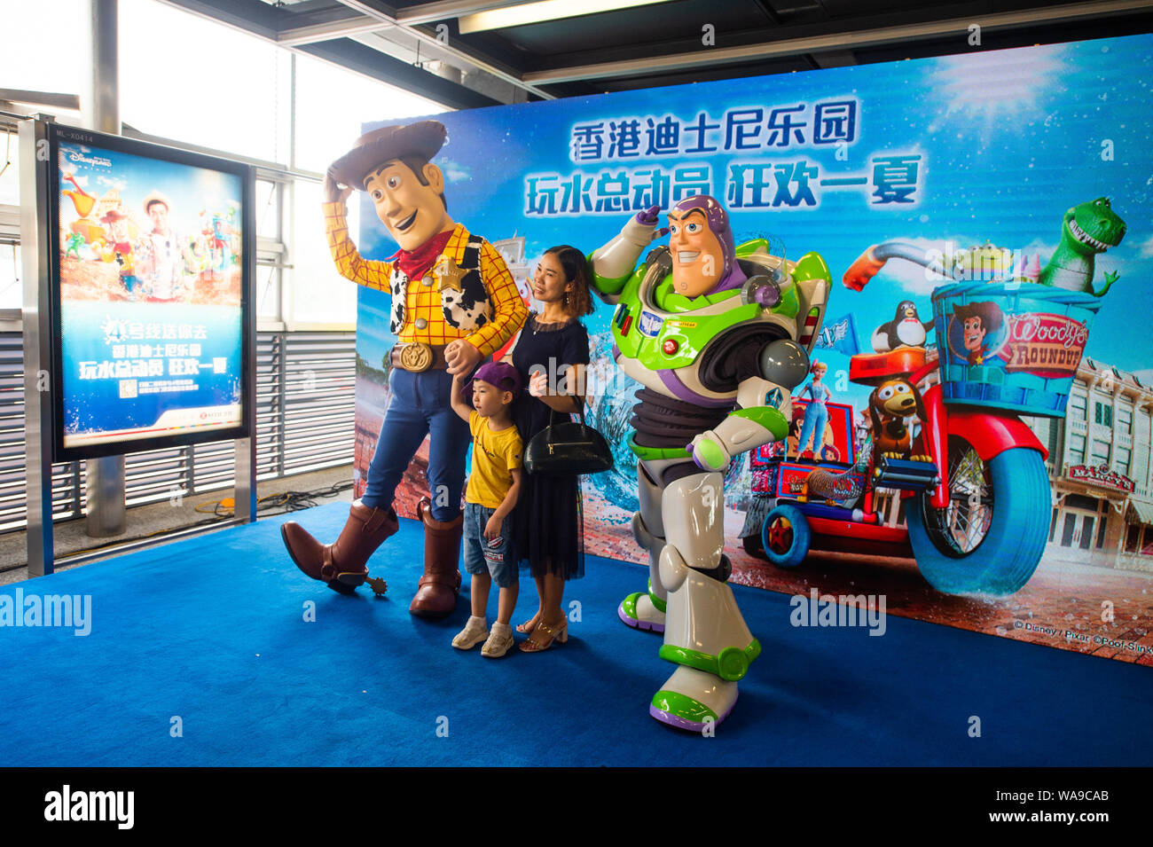 Animatori vestiti di Buzz Lightyear e Woody da Disney film di animazione Toy Story pongono in corrispondenza di una stazione della metropolitana della linea 4 della metropolitana nella città di Shenzhen, s Foto Stock