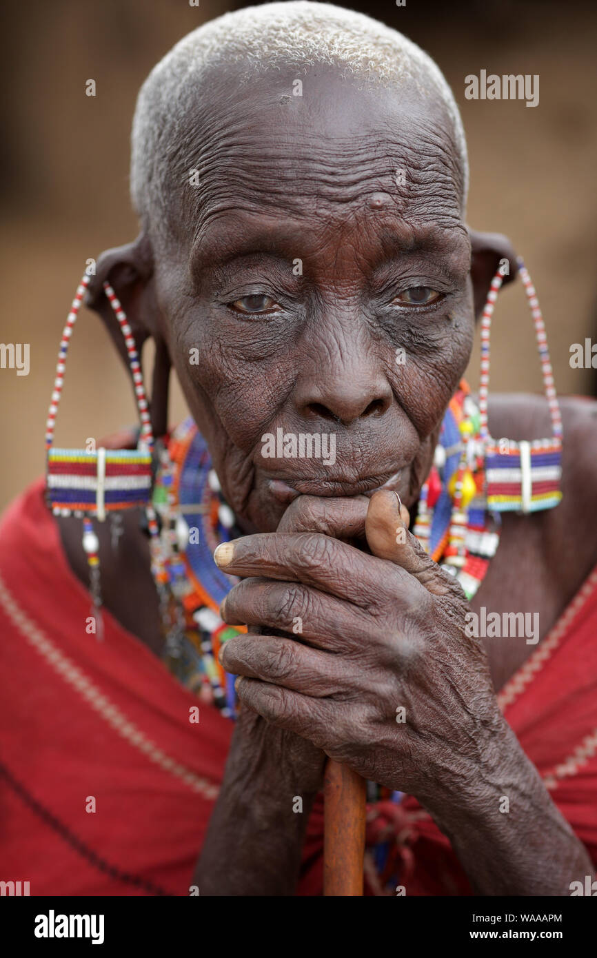 Vecchia donna Masai con tradizionale orecchini pone per un ritratto in Loitoktok, Kenya. Foto Stock