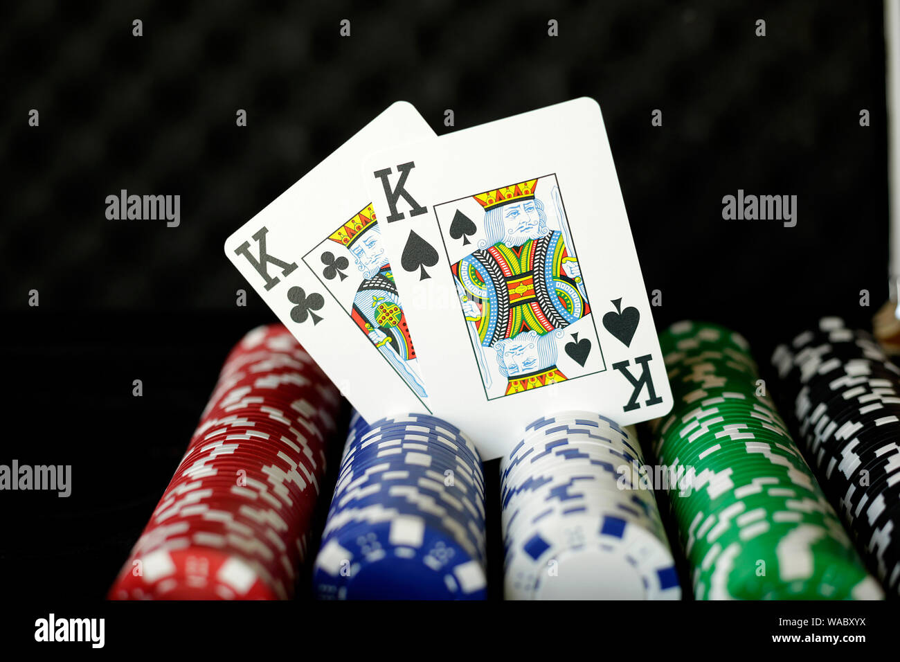 Coppia di carte da gioco dei re in posizione verticale su chip di poker Foto Stock