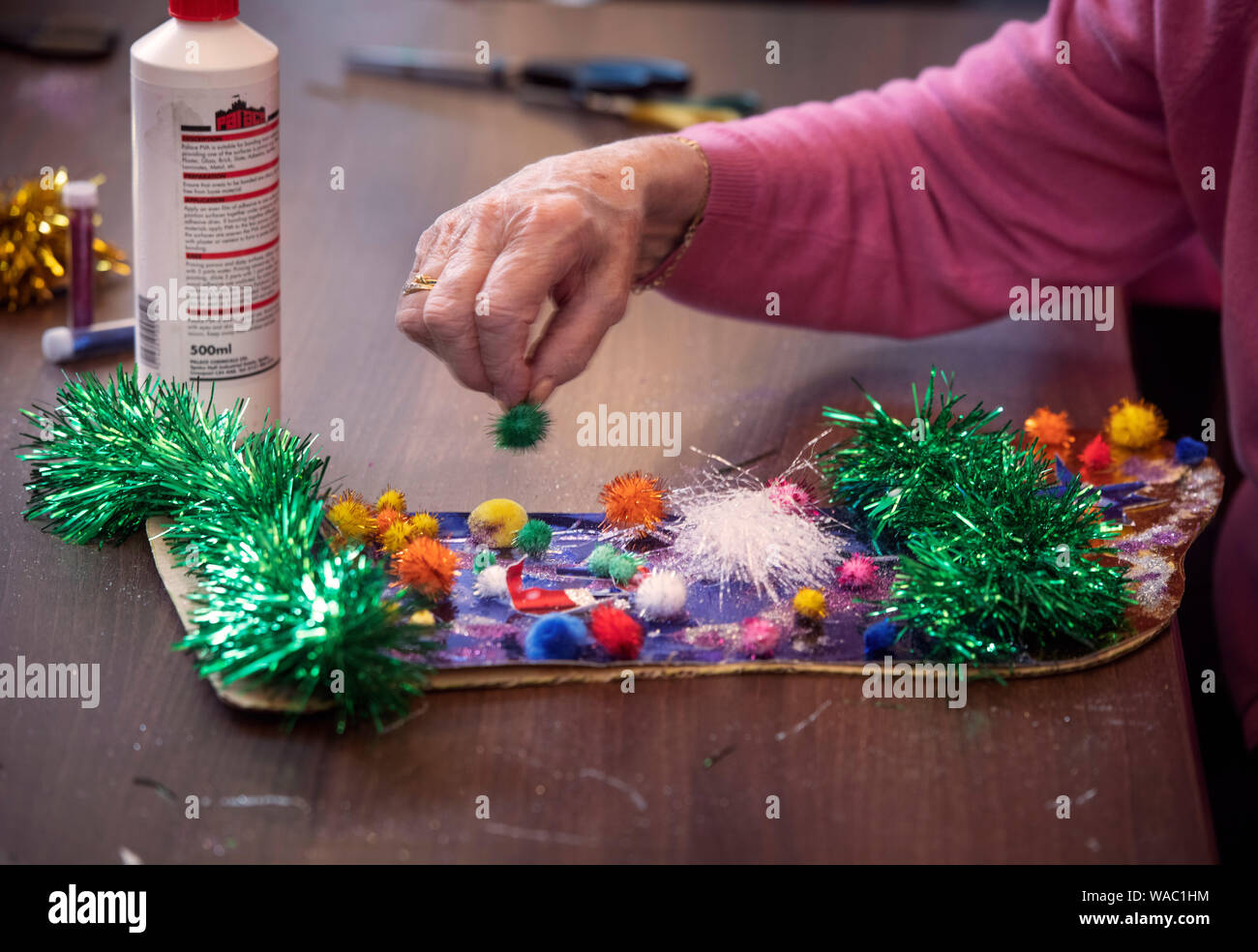 Allievi per l area di Bristol visitare case di cura per rendere il Natale decorazioni con i residenti in un progetto organizzato da una carità viva attività Foto Stock