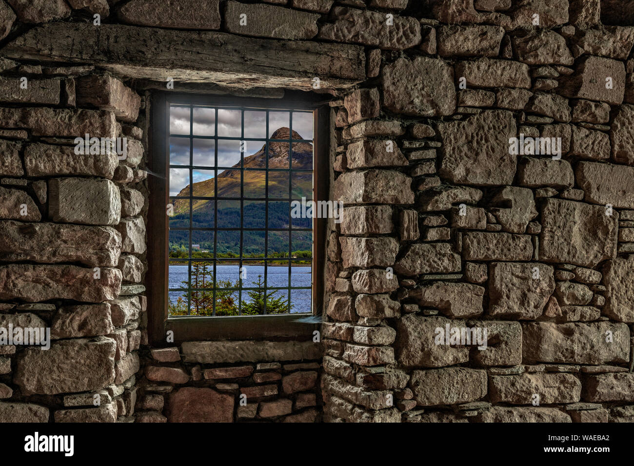 Guardando attraverso una finestra in un muro di pietra a Loch Leven Foto Stock
