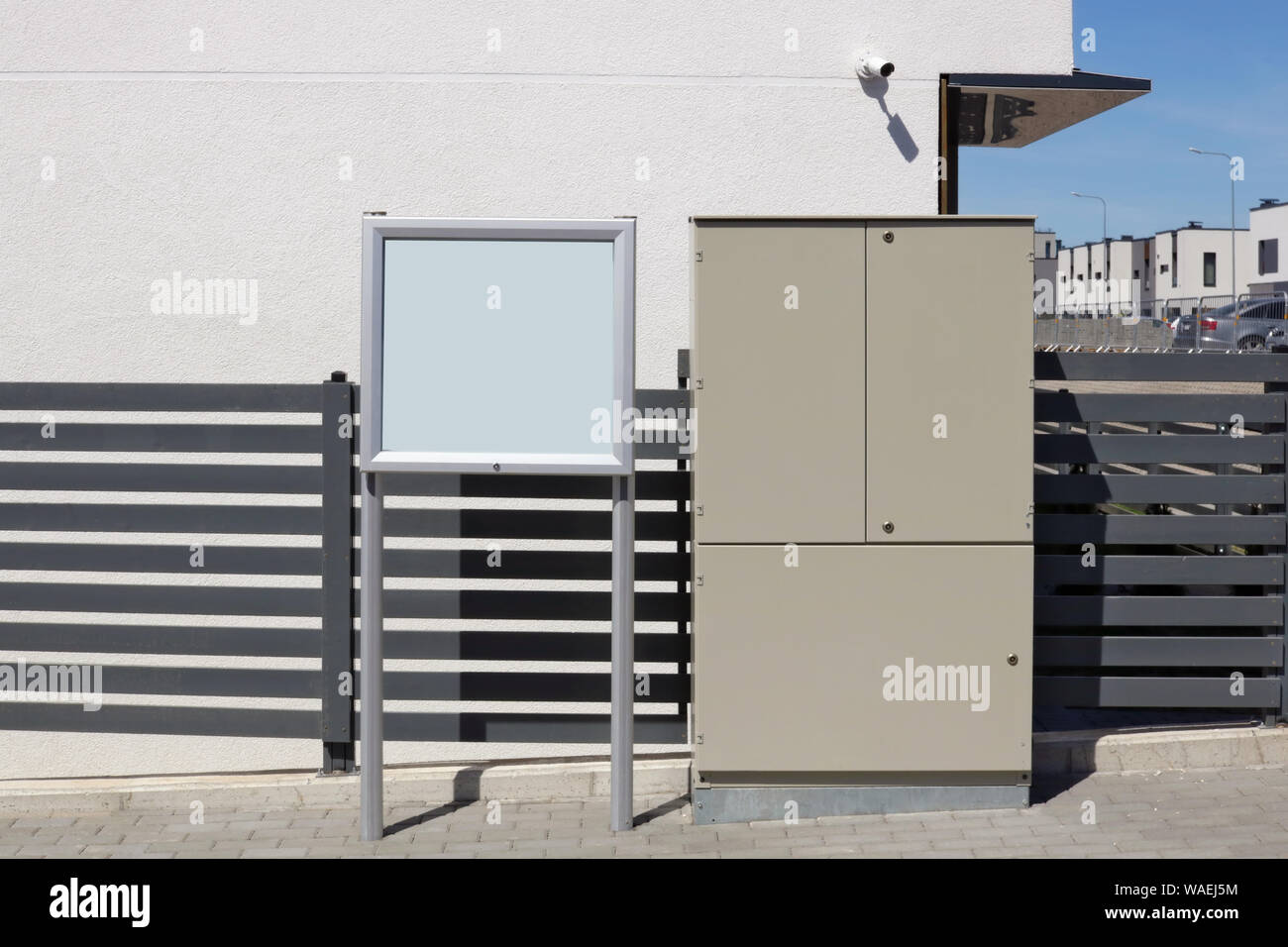 Svuotare il bulletin board, acciaio elettrico scatola di distribuzione e videocamera di sorveglianza in un nuovo standard moderna area residenziale Foto Stock
