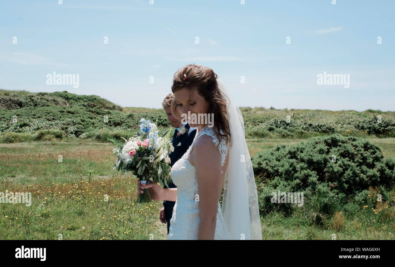 Ritratto di sposa e lo sposo sorridere camminando su una giornata d'estate Foto Stock