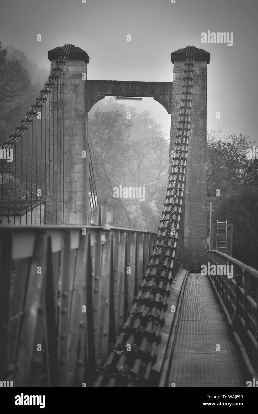 Francia, Cajarc. Nebbia mattutina sul ferro ponte sopra il fiume Lot. Foto Stock