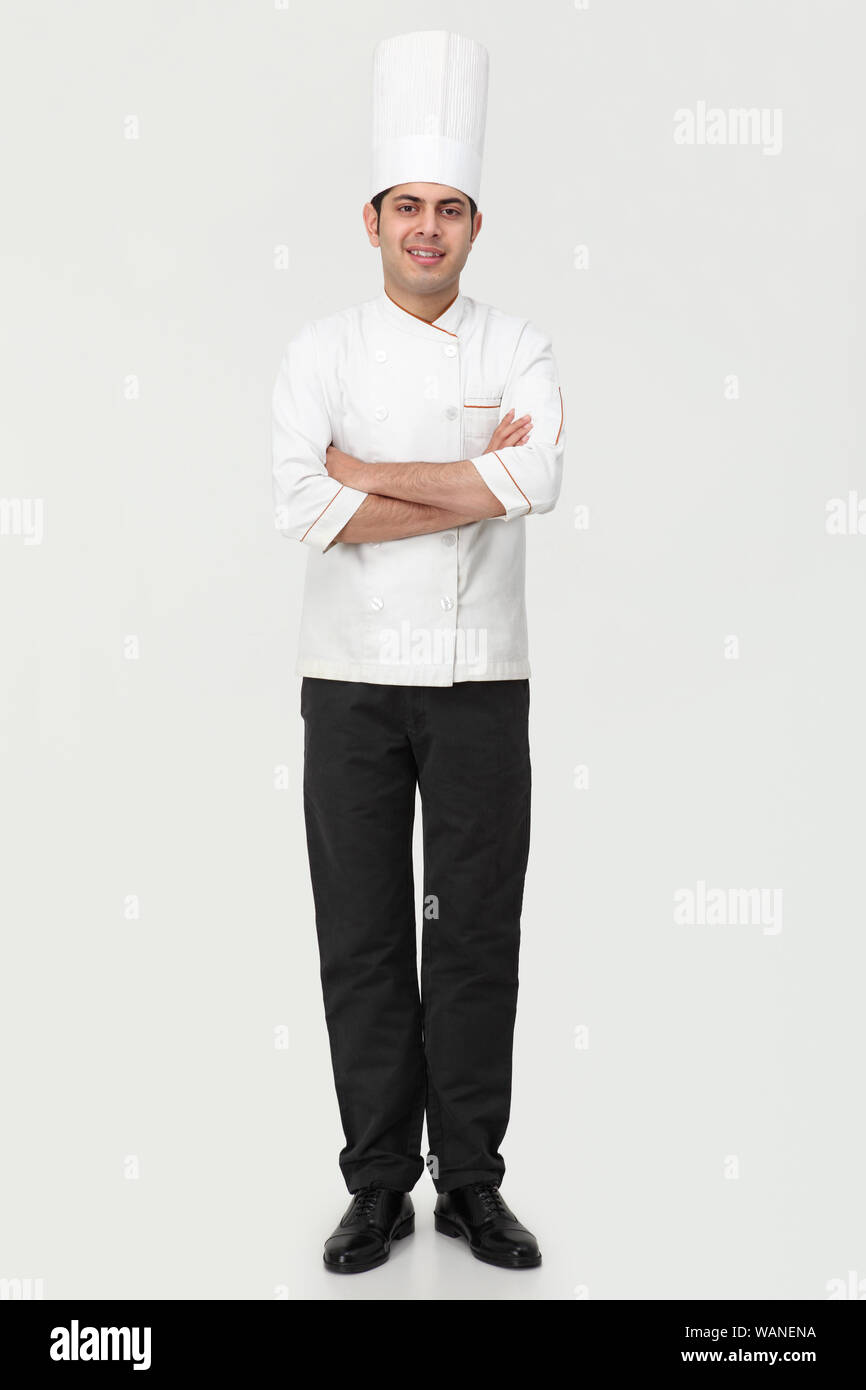 Chef in piedi con le braccia incrociate Foto Stock