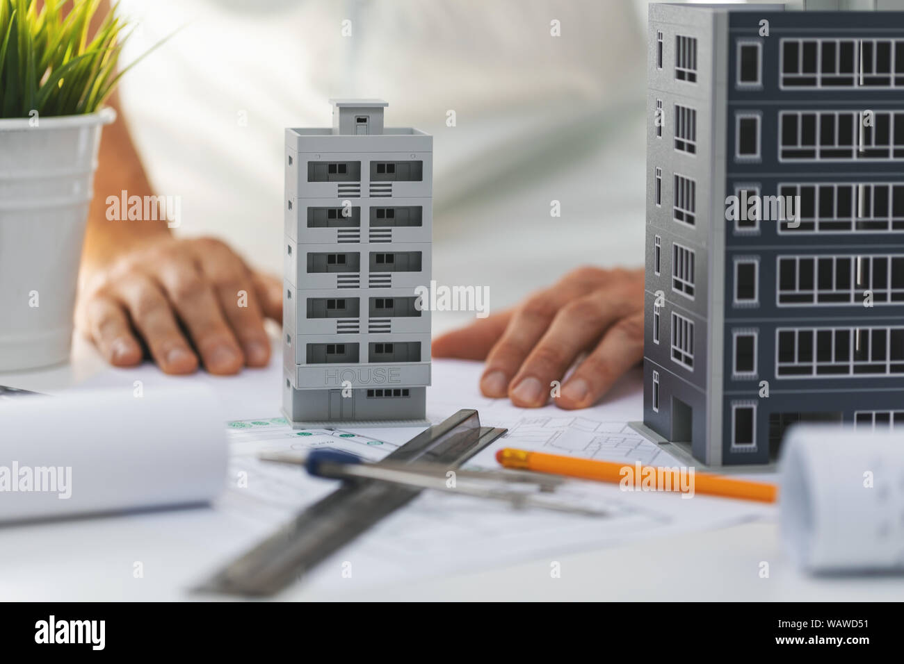 Ingegneria civile sviluppo di alloggiamento - casa di modelli in scala e blueprint sulla scrivania in ufficio Foto Stock