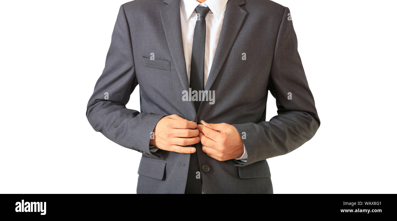 Giovane imprenditore abbottonatura suo completo grigio permanente intaglio isolato, contro uno sfondo bianco. Foto Stock