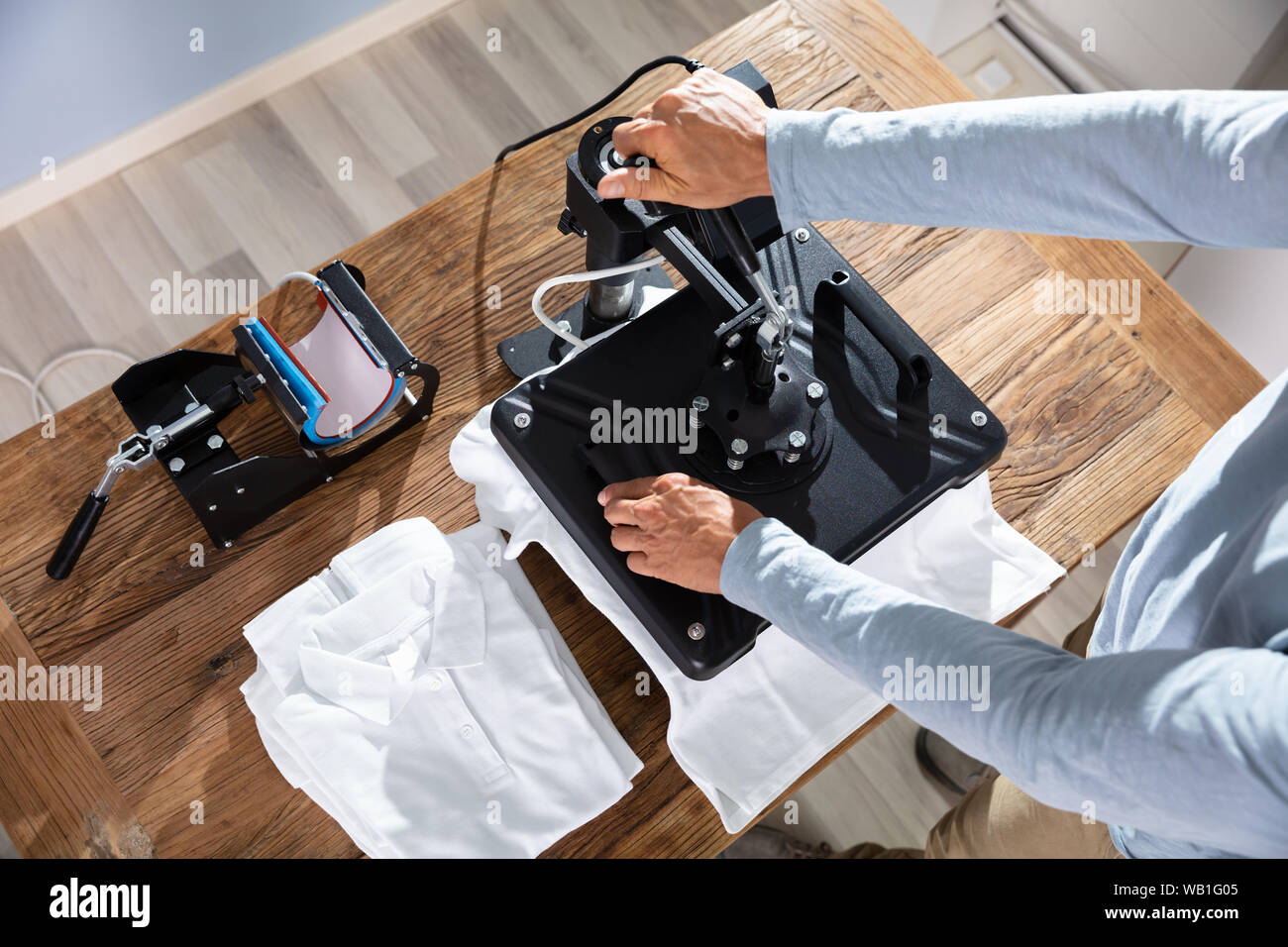 L'uomo immagine di stampa su T-Shirt in officina Foto Stock