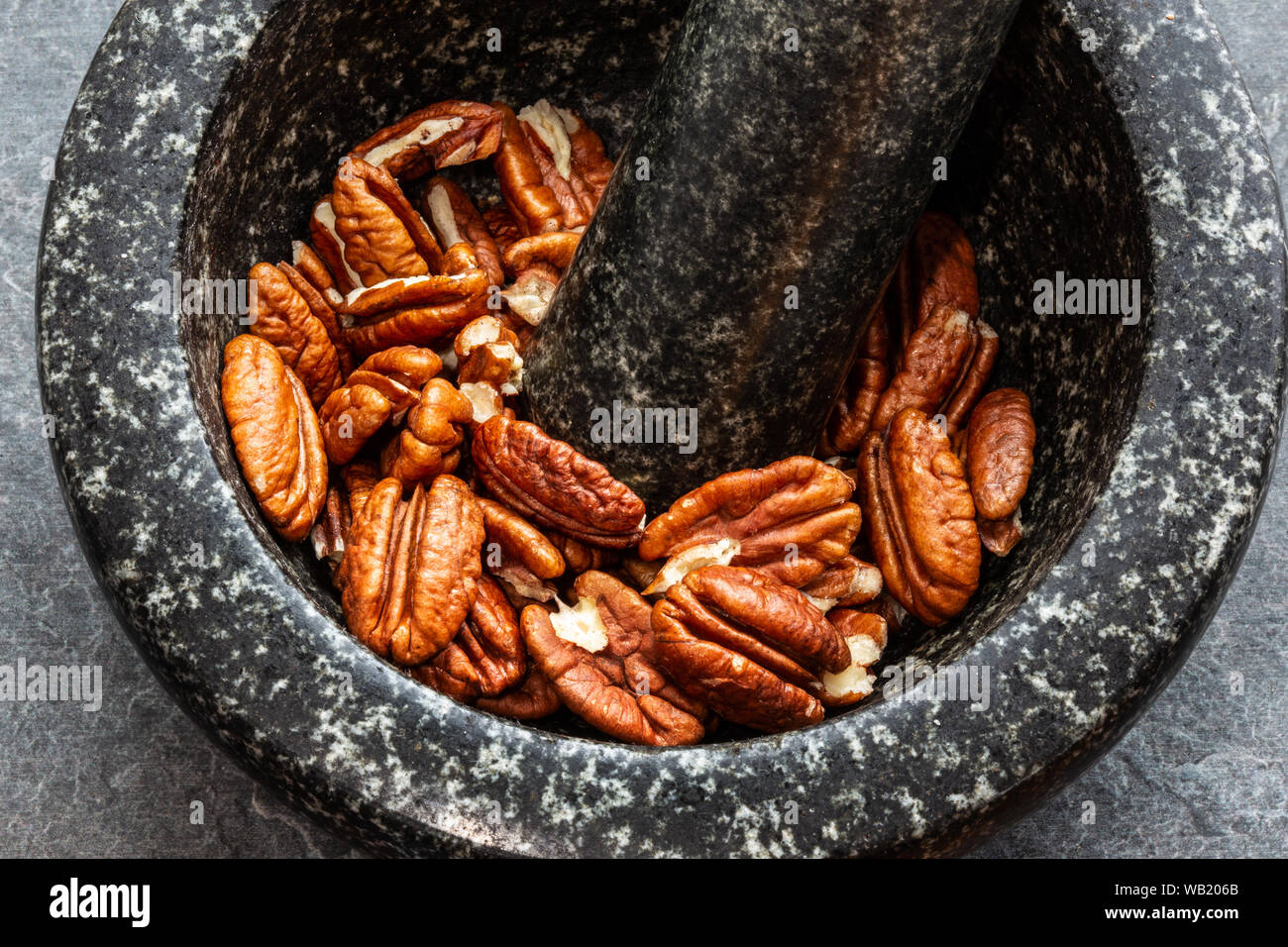 Noci pekan in pietra nera peel Foto Stock
